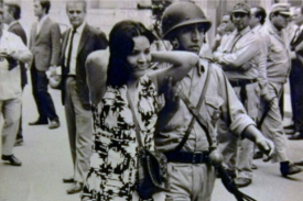 black and white photo of a young woman being detained by police in Argentina